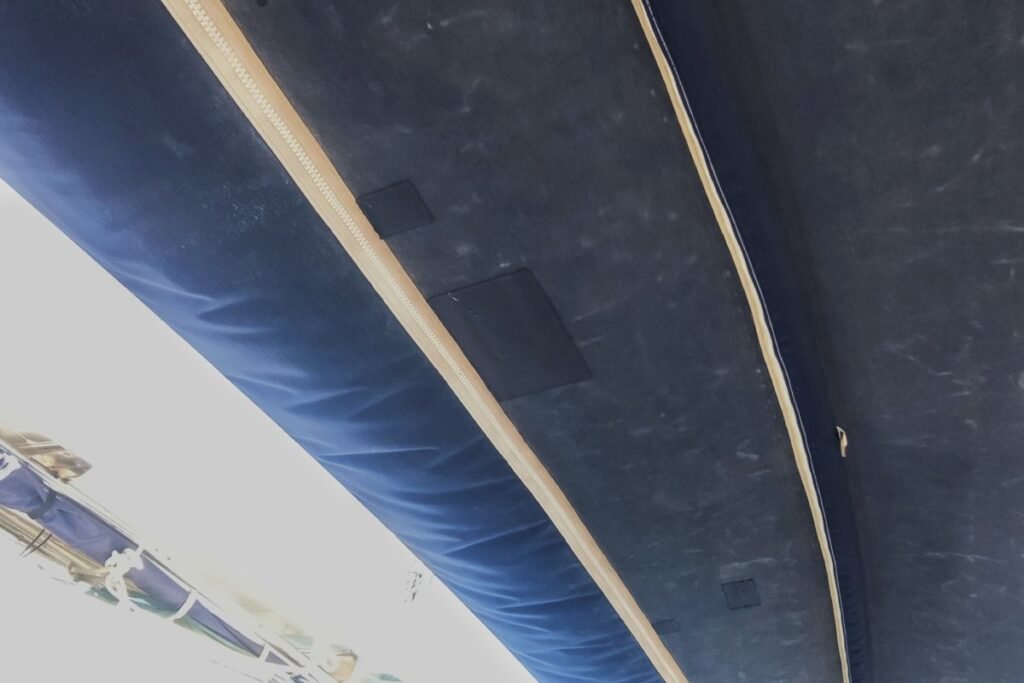 Réparation de toile et remplacement de fermetures sur une capote de bateau